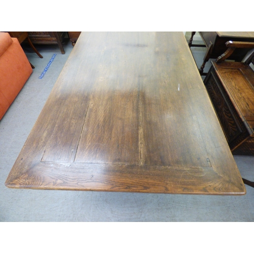 A mid 18thC and later oak refectory table, the one piece top over twin ...