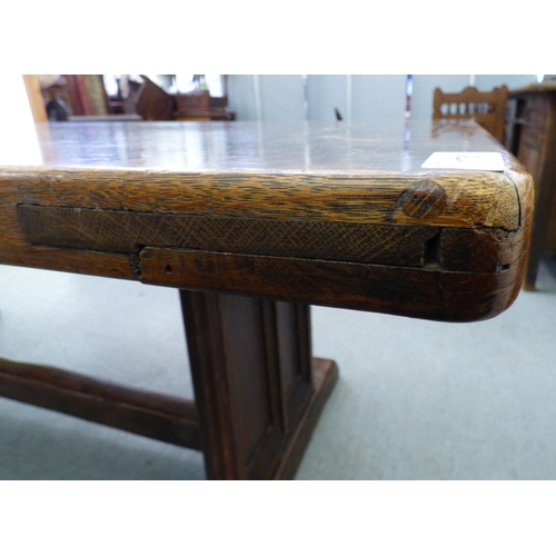 A mid 18thC and later oak refectory table, the one piece top over twin ...