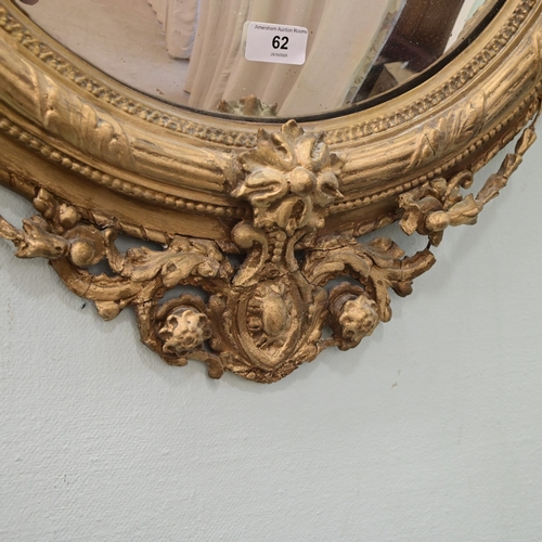 A Regency gilt gesso convex mirror, surmounted by a bird 31