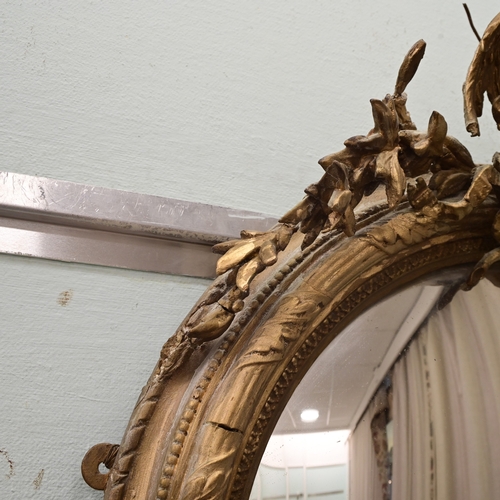 A Regency gilt gesso convex mirror, surmounted by a bird 31
