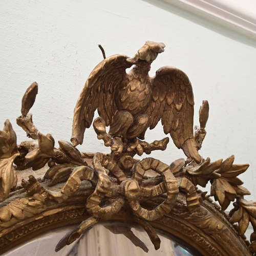A Regency gilt gesso convex mirror, surmounted by a bird 31