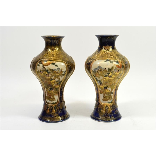 10 - A pair of Japanese Satsuma vases, Meiji, inverse baluster form, each with three scenic panels within... 