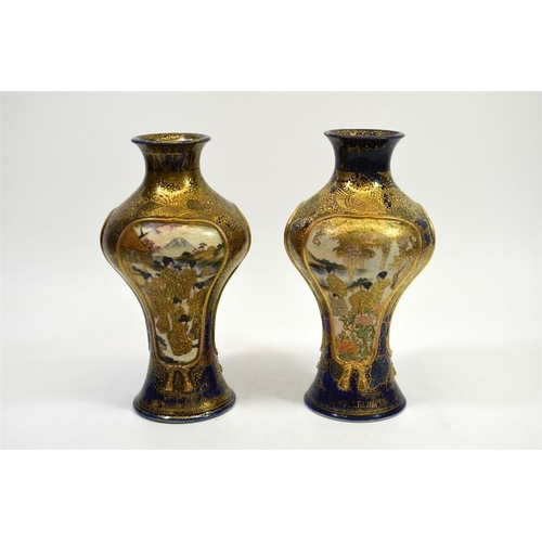 10 - A pair of Japanese Satsuma vases, Meiji, inverse baluster form, each with three scenic panels within... 