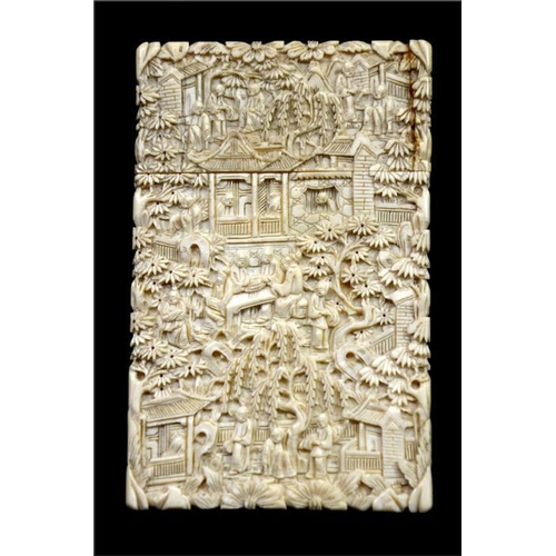 106 - λ A Chinese carved ivory card case, 19th century, decorated with an extensive figural garden landsca... 