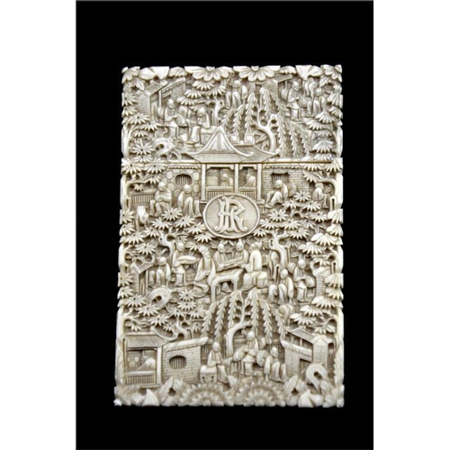 107 - λ A Chinese carved ivory card case, 19th century, decorated in relief with extensive garden landscap... 