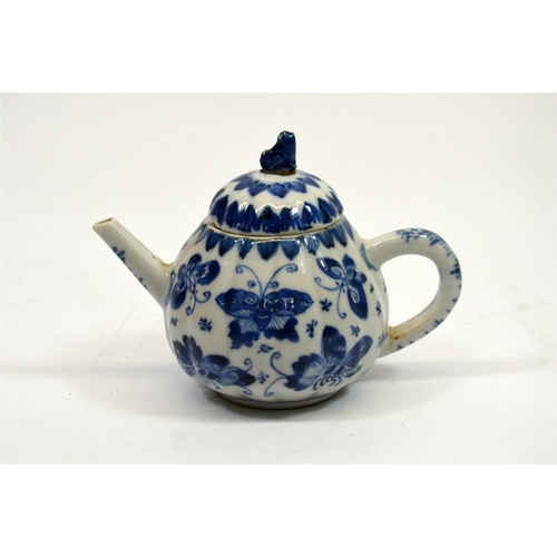 11 - A small Chinese blue and white teapot, 18th century, decorated with butterflies, 11cm high