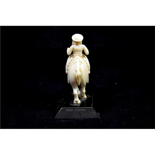 110 - λ An Oriental carved ivory figure of a man on camel, 19th century, Anglo Indian, on black marble bas... 