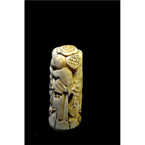 111 - λ A Japanese carved ivory sword pommel, Meiji, 19th century, carved and reticulated with skeleton, z... 