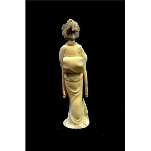 112 - λ A Japanese carved ivory okimono, Meiji, 19th century, modelled as a Geisha, 14cm high