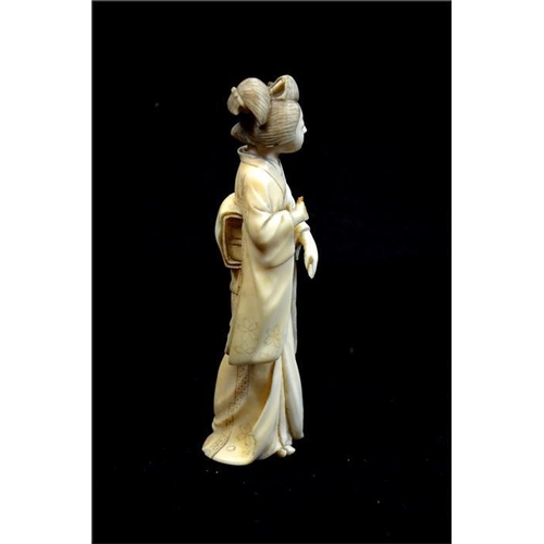 112 - λ A Japanese carved ivory okimono, Meiji, 19th century, modelled as a Geisha, 14cm high