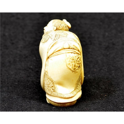 113 - λ A Japanese ivory okimono of a haunched figure, Meiji period, signed, height 7.5cm