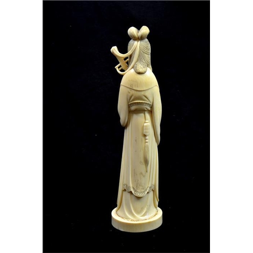 116 - λ A Japanese carved ivory Okimono, Meiji, late 19th century, modelled as a musician holding a string... 