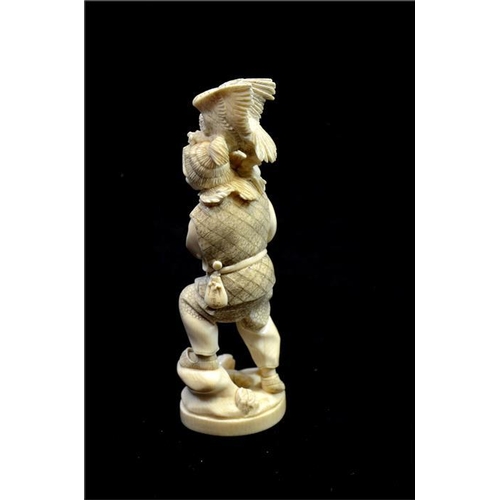 118 - λ A Japanese carved ivory okimono, Meiji, late 19th century, modelled as a hunter with gun and birds... 