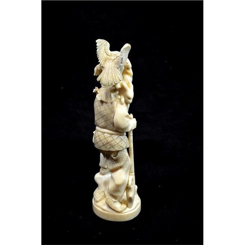 118 - λ A Japanese carved ivory okimono, Meiji, late 19th century, modelled as a hunter with gun and birds... 