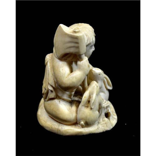 121 - λ A Japanese carved ivory okimono, Meiji, 19th century, modelled as a child with axe and rabbits, 7c... 