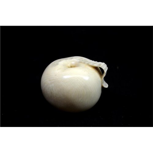 123 - λ A Japanese carved ivory okimono, Meiji, 19th century, modelled as an apple, part peeled, 6cm diame... 