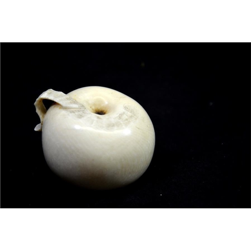 123 - λ A Japanese carved ivory okimono, Meiji, 19th century, modelled as an apple, part peeled, 6cm diame... 