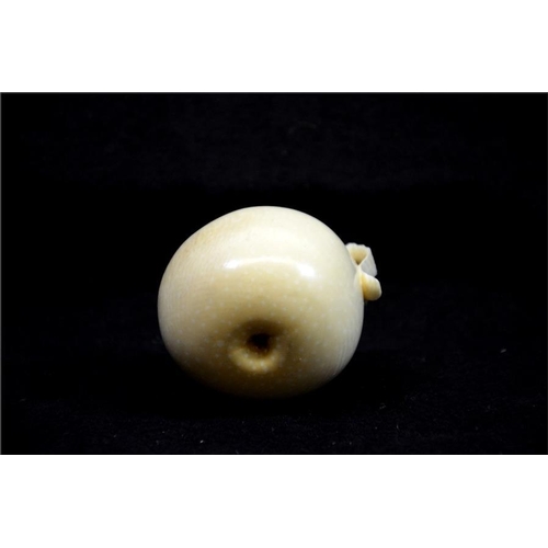 123 - λ A Japanese carved ivory okimono, Meiji, 19th century, modelled as an apple, part peeled, 6cm diame... 