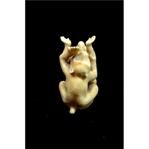 124 - λ A Japanese carved ivory okimono, Meiji, 19th century, modelled as an infant and adult monkey playi... 