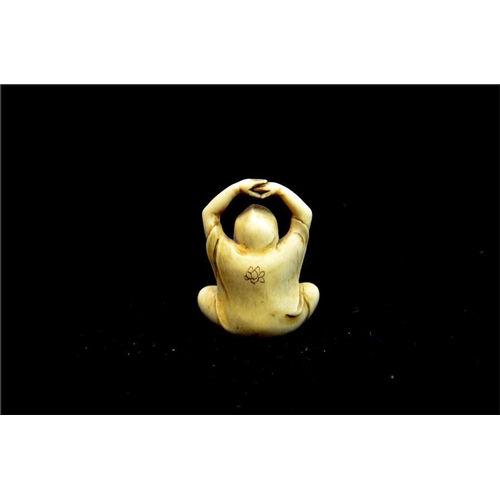 126 - λ A Japanese carved ivory netsuke, Meiji, 19th century, modelled as a yogi, arms raised, signed, 4.5... 