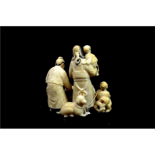 127 - λ A Japanese carved ivory okimono, Meiji or earlier, 19th century, modelled  as a family gathered ar... 