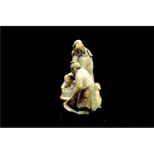 127 - λ A Japanese carved ivory okimono, Meiji or earlier, 19th century, modelled  as a family gathered ar... 