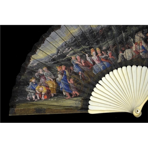 134 - λ An early 18th century ivory fan, with ivory sticks and guards, the guards carved with figures and ... 