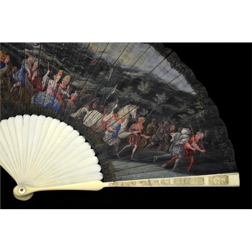 134 - λ An early 18th century ivory fan, with ivory sticks and guards, the guards carved with figures and ... 