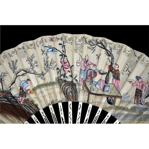 147 - An 18th century decoupé Chinoiserie fan, with carved and pierced guards and sticks, the upper guards... 