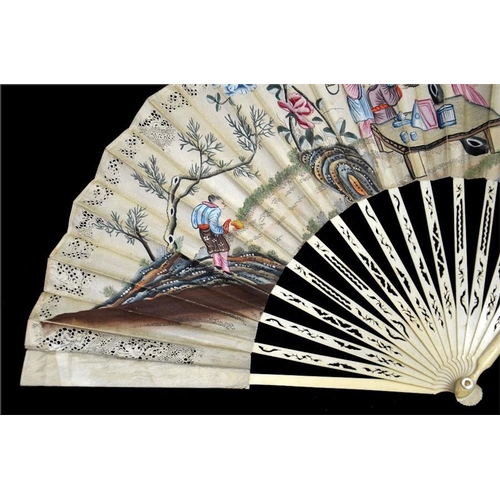 147 - An 18th century decoupé Chinoiserie fan, with carved and pierced guards and sticks, the upper guards... 