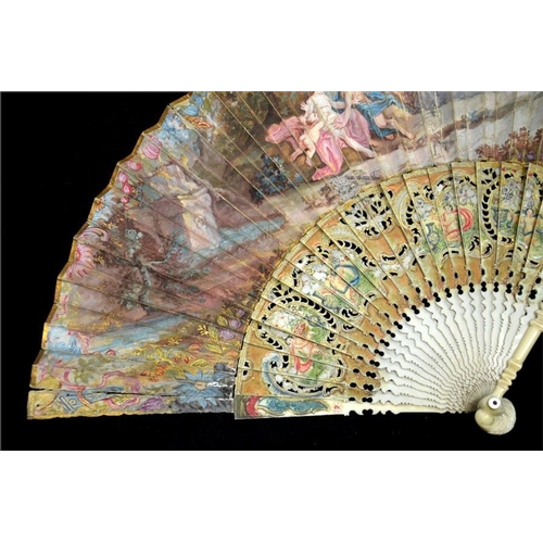 148 - λ A mid 18th century painted ivory fan, with ivory guards and sticks elaborately carved, pierced, pa... 