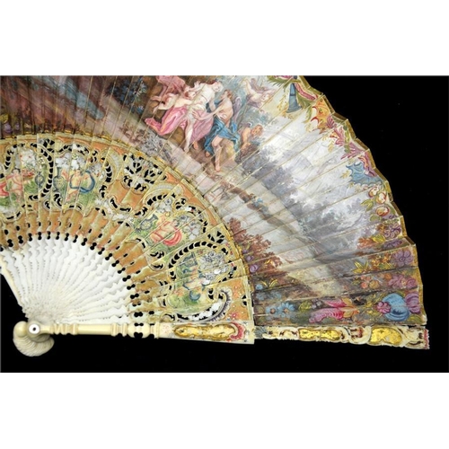 148 - λ A mid 18th century painted ivory fan, with ivory guards and sticks elaborately carved, pierced, pa... 