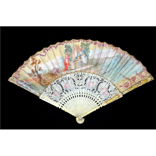 148 - λ A mid 18th century painted ivory fan, with ivory guards and sticks elaborately carved, pierced, pa... 