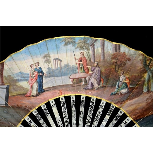 153 - λ A late 18th century ivory fan, with elaborately carved and pierced guards and sticks, the guards c... 