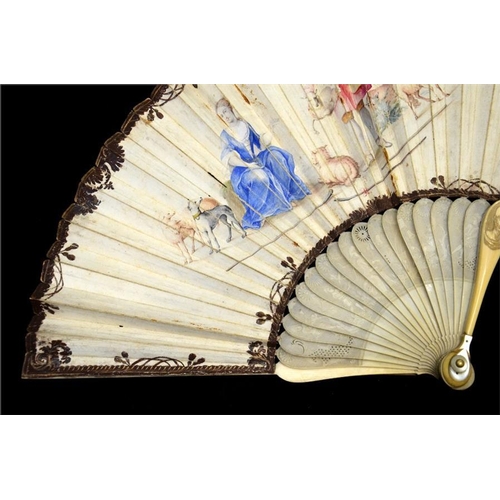 155 - λ An early 18th century ivory fan, with carved ivory sticks and guards, the guards carved with figur... 