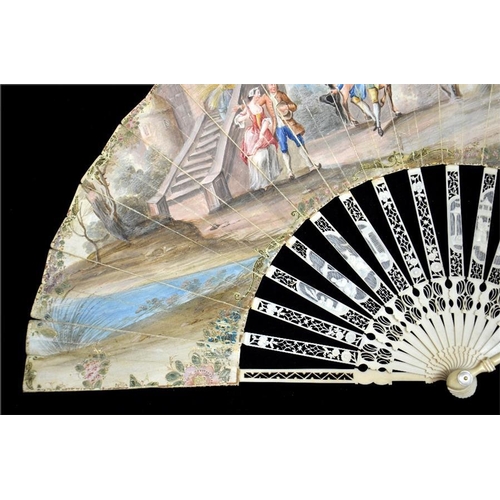 163 - λ An 18th century ivory fan, with elaborately carved and pierced Chinoiserie guards and sticks, the ... 