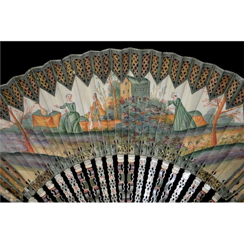 174 - An 18th century decoupé fan, hand painted in tones of green and orange with a scene of a lady inviti... 