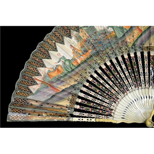 174 - An 18th century decoupé fan, hand painted in tones of green and orange with a scene of a lady inviti... 