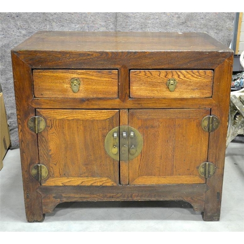 183 - A 19th century Chinese elm chest, two drawers over cupboard doors