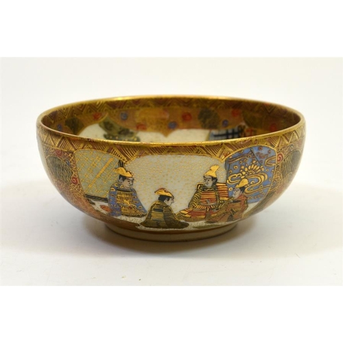 19 - A Japanese Satsuma bowl, Meiji, the centre decorated with seated deities in a temple landscape, sign... 