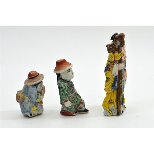 40 - Three Chinese porcelain snuff bottles, each modelled as a figure, polychrome decorated, including ma... 