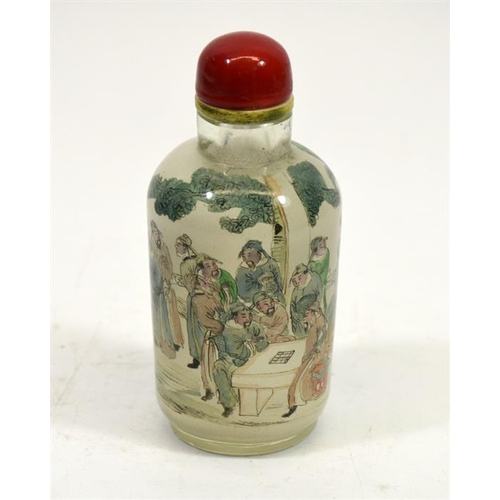 67 - A Chinese glass snuff bottle, cylindrical form, reverse painted with courtiers playing games in a ga... 