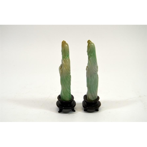 70 - A pair of carved Chinese jade type figures, on hardwood stands, 13cm high (2)