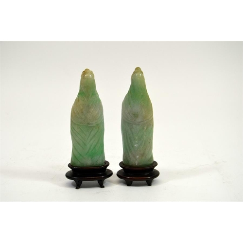 70 - A pair of carved Chinese jade type figures, on hardwood stands, 13cm high (2)