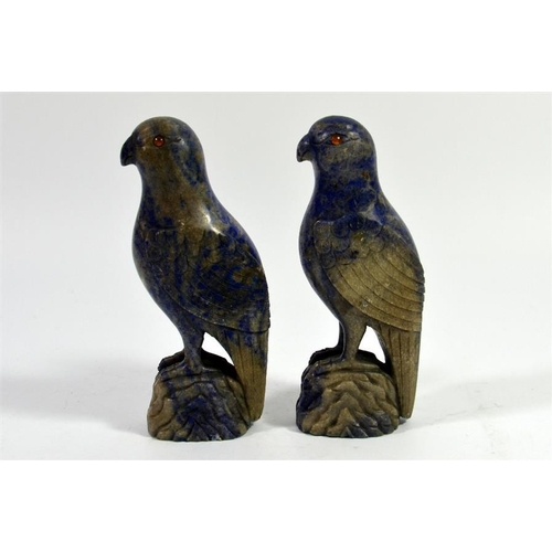 72 - A pair of Oriental carved lapis parrots, set with amber coloured eyes, 17cm high (2)