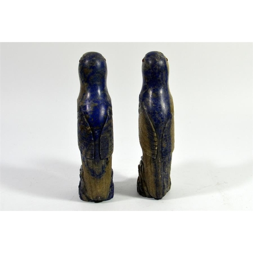 72 - A pair of Oriental carved lapis parrots, set with amber coloured eyes, 17cm high (2)