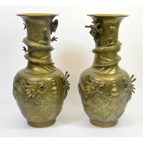 74 - A large pair of Chinese bronze vases, cast in relief with dragons and pearls, cast marks set to the ... 