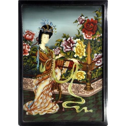 75 - A pair of Chinese reverse painted glass pictures, depicting women in garden scenes with peonies, 66c... 