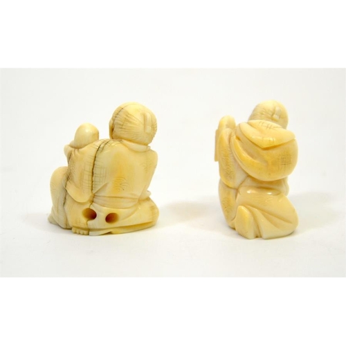 77 - Two 19th century Japanese netsuke, Meiji, modelled as crouching figures, one holding a book (2)