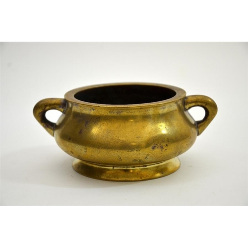 78 - A Chinese bronze censer, squat baluster form with twin handles, Xuande cast seal mark, 16cm wide, 85... 